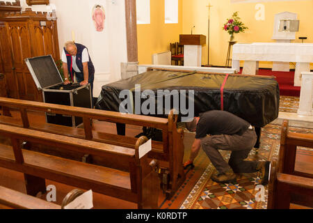 Steinway Grand Piano being moved into a church, Ireland Stock Photo