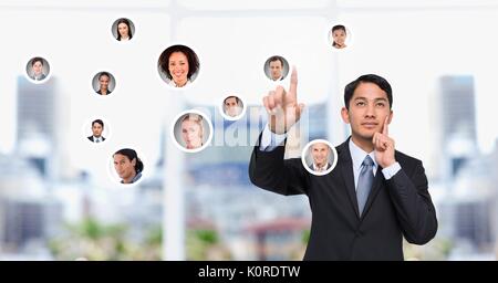 Digital composite of Businessman interacting and choosing a person from group of people interface Stock Photo
