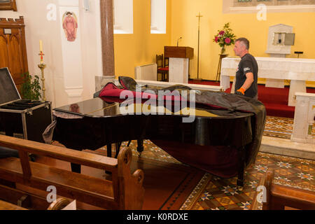 Steinway Grand Piano being moved into a church, Ireland Stock Photo