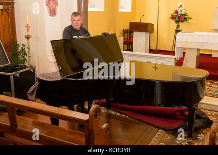 Steinway Grand Piano being moved into a church, Ireland Stock Photo