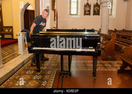 Steinway Grand Piano being moved into a church, Ireland Stock Photo