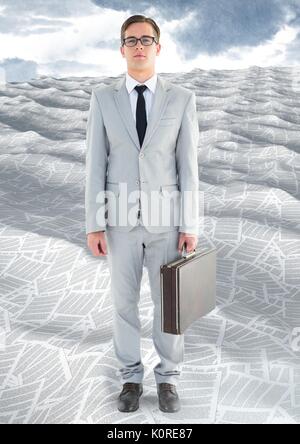 Digital composite of Businessman in sea of documents under sky clouds with briefcase Stock Photo