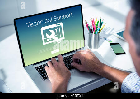 Technical support text with tool against overhead of masculine hand typing on laptop Stock Photo