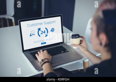 Icons and customer support text against woman using laptop Stock Photo