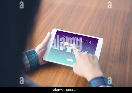 Search assistance text with icons against woman using a digital tablet Stock Photo