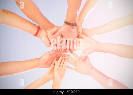 Digital composite image of smile today text against directly below shot of friends stacking hands Stock Photo