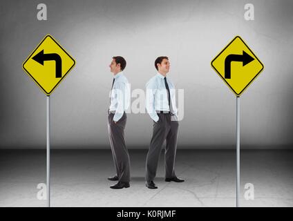 Digital composite of Left or right arrows on road signs with Businessman looking in opposite directions Stock Photo