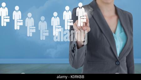 Digital composite of Businesswoman interacting and choosing a person from group of people icons Stock Photo