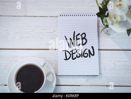 Digital composite of Table top with a notebook with web graphics Stock Photo