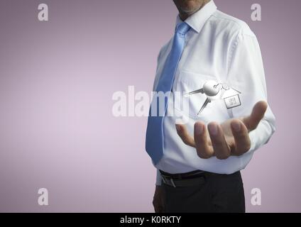 Digital composite of Business man holding keys Stock Photo