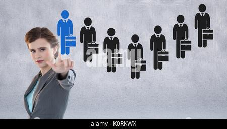 Digital composite of Businesswoman interacting and choosing a person from group of people icons Stock Photo