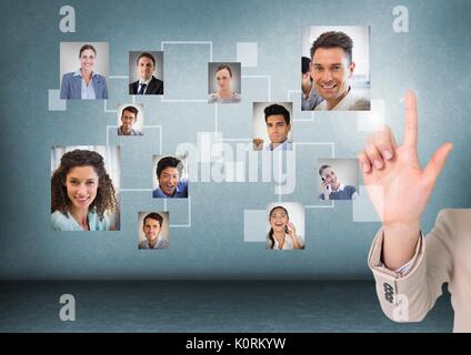 Digital composite of Businesswomans' hand interacting and choosing a person from group of people interface Stock Photo
