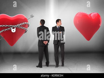 Digital composite of Heart in chains or heart with Businessman looking in opposite directions Stock Photo