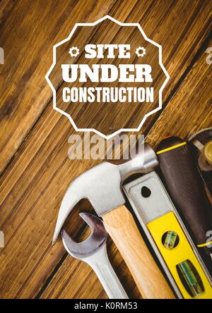 Digital composite of Website under construction text against tools photo Stock Photo