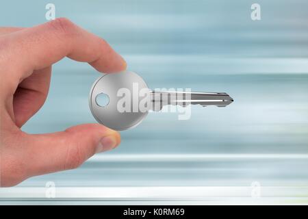 Digital composite of Hand holding keys Stock Photo