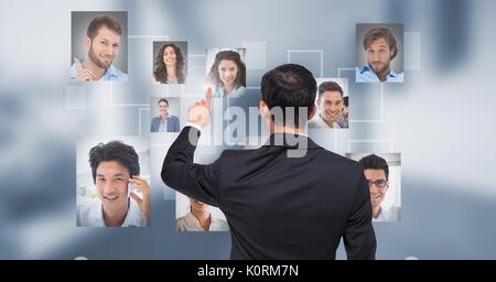 Digital composite of Businessman interacting and choosing a person from group of people interface Stock Photo