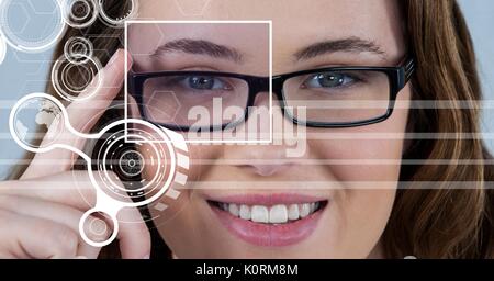 Digital composite of woman with eye focus box over glasses and detail and lines interface Stock Photo