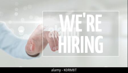 Digital composite of Hand interacting with weâ€™re hiring business text against white background Stock Photo