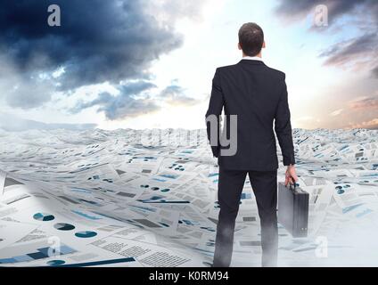 Digital composite of Businessman holding briefcase in sea of documents under sky clouds opening Stock Photo