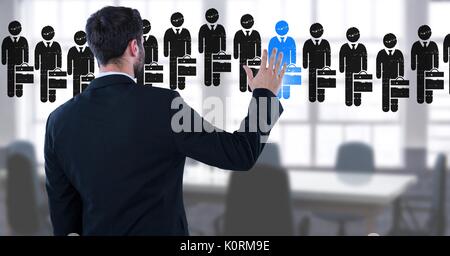 Digital composite of Businessman interacting and choosing a person from group of people icons Stock Photo