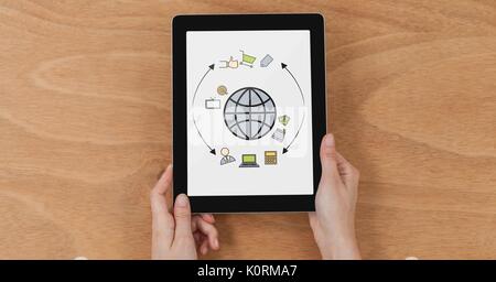 Digital composite of Table top with a tablet with web graphics on the screen Stock Photo
