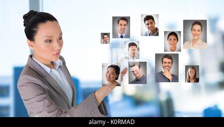 Digital composite of Businesswoman interacting and choosing a person from group of people interface Stock Photo