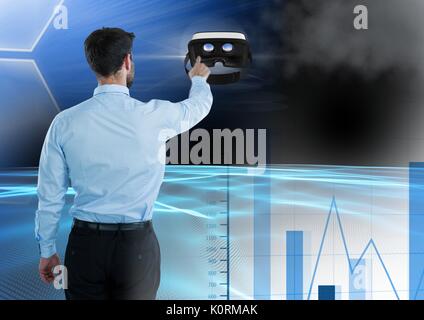 Digital composite of Man touching and interacting with virtual reality headset with transition effect Stock Photo
