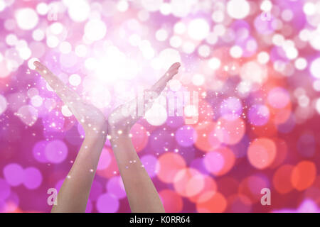 Hands gesturing against white background against glowing background Stock Photo