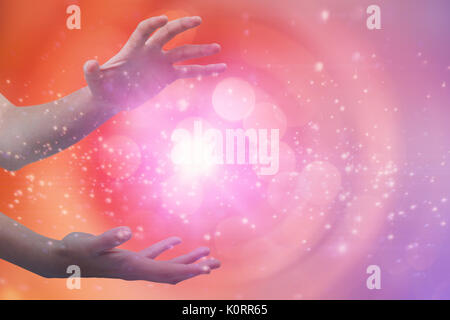 Hands gesturing against white background against glowing background Stock Photo