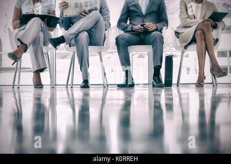 Group of well dressed business people waiting in waiting room Stock Photo