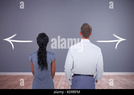 Wear view of business people against room with wooden floor Stock Photo