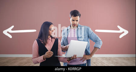 Business colleagues using laptop against room with wooden floor Stock Photo