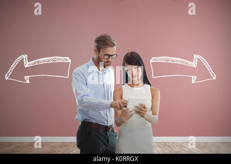 Business people looking at tablet against room with wooden floor Stock Photo