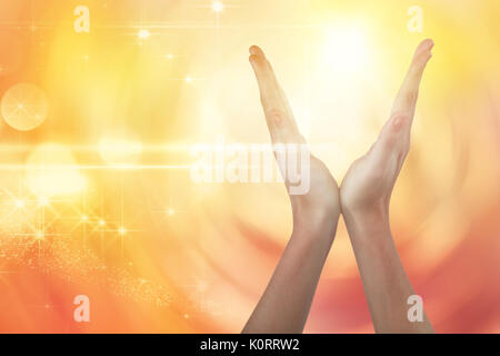 Hands gesturing against white background against glowing background Stock Photo
