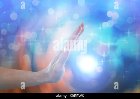 Hand of man pretending to touch invisible screen against glowing background Stock Photo