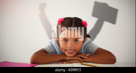 Businessman jumping while holding briefcase against young girl with her head on desk against white background Stock Photo
