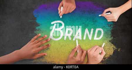 Business people writing with chalks against close-up of blackboard Stock Photo