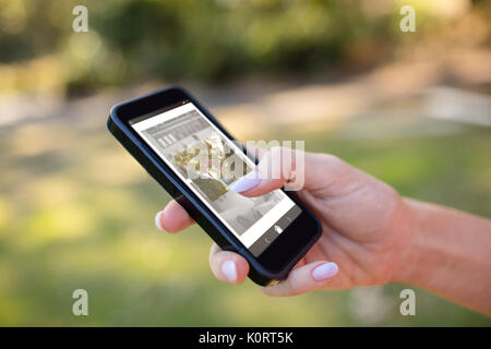 Digital composite image of gate amidst trees and chair against cropped hands of woman using phone Stock Photo
