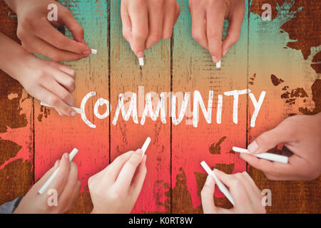 Business people writing with chalks against wooden background Stock Photo