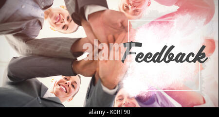 Business team standing hands together against feedback text against white background Stock Photo
