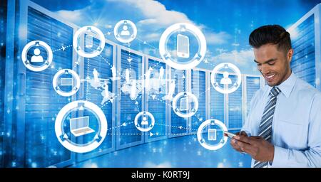 Digital composite of Happy business man holding a phone and graphics in server room Stock Photo