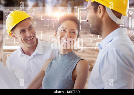 Happy architect discussing over blueprint against high angle view of muddy construction site Stock Photo