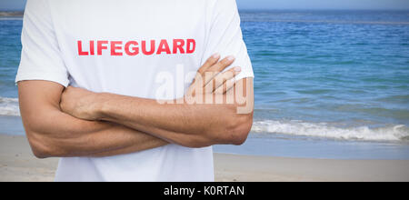 Mid section of male lifeguard against scenic view of beach Stock Photo