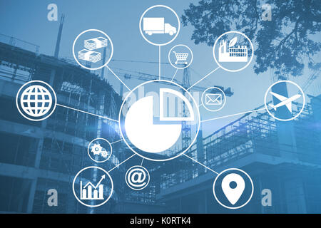 Composite image of pie chart amidst various icons against cranes at construction site Stock Photo