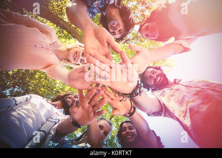 Close up of inspire text of coral paint against friends forming hands stack Stock Photo
