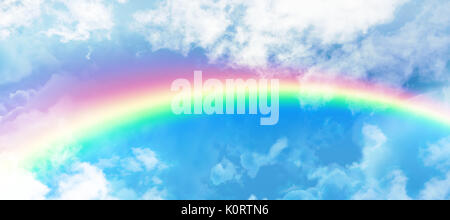 Graphic image of vibrant color rainbow against clouds against blue sky Stock Photo
