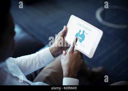 Live support text with human representations against cropped image of businessman using tablet Stock Photo