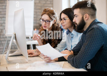 Group of young designers working as team Stock Photo