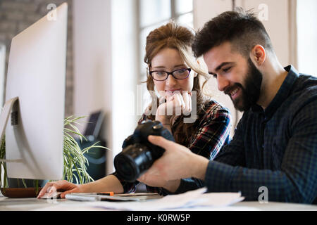 Picture of young attractive designers looking at camera Stock Photo