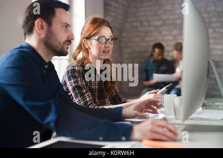 Portrait of young designers working on computer Stock Photo